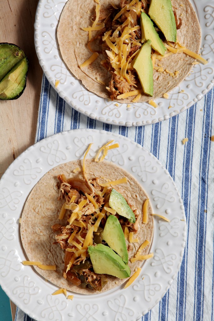 Slow Cooker Chicken Tacos are a no-fuss weeknight entree. Pop the chicken and veggies in the slow cooker before work, and come home to a homemade meal. Shred the chicken, place it on your favorite kind of tortilla, top with cheese and avocado (or any other topping you're digging), and dinner is served!