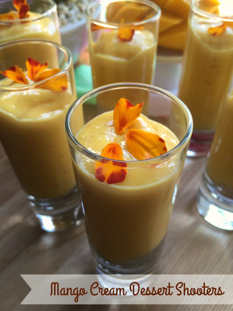Mango cream dessert shooters made with champagne mangoes, condensed milk and cookie crumbles. Garnished with edible marigold petals.