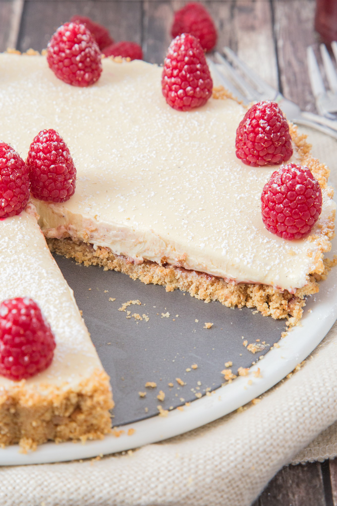 A crunchy biscuit base is topped with tart raspberry coulis and silky smooth white chocolate ganache to make this epic Raspberry and White Chocolate Ganache Tart.