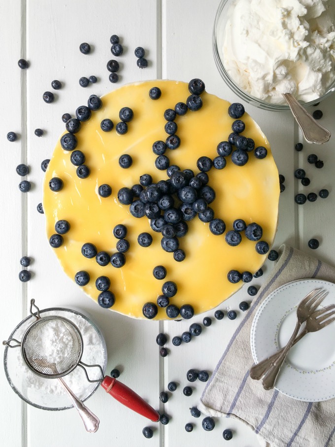 This No Bake Blueberry Lemon Cheesecake is a fresh, tangy and sweet dessert that does not require an oven to make! Enjoy fresh blueberries over sweet and tangy lemon curd with smooth & creamy cheesecake center and a graham cracker crust! Bring this delicious dessert to your next gathering. #SoFabFood