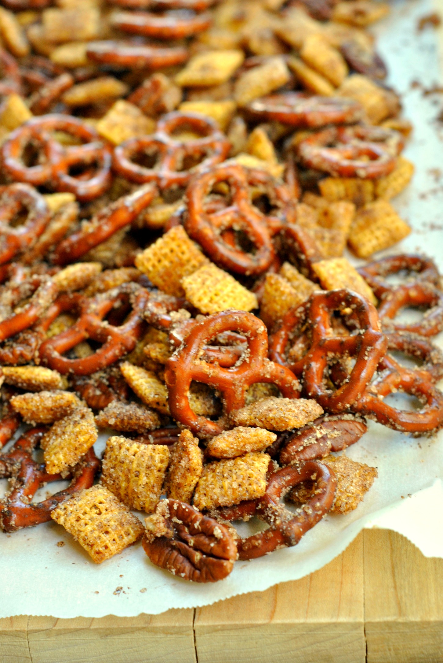 Cinnamon Sugar Snack Mix Recipe is perfect for satisfying your snack time cravings! Pretzels, pecans, candy, and cereal coated in cinnamon sugar make this mix so indulgent!