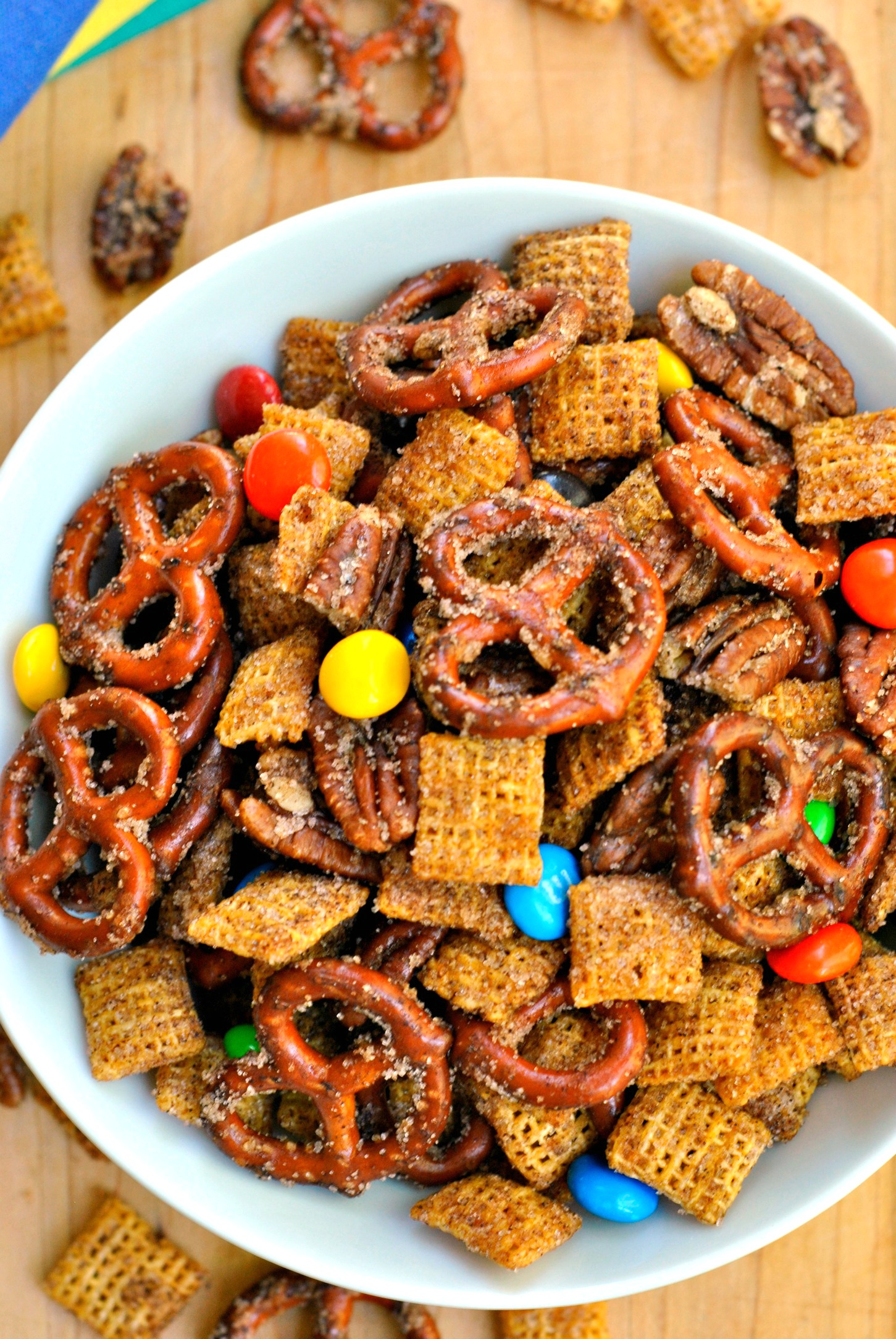 Cinnamon Sugar Snack Mix Recipe is perfect for satisfying your snack time cravings! Pretzels, pecans, candy, and cereal coated in cinnamon sugar make this mix so indulgent!