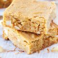The PKP Way | A cookie-like exterior and a cake-like interior, make these Coconut Macadamia Nut Blondies the perfect transportable treat for any celebration.