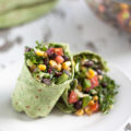 Shaved brussels sprouts, chopped kale, black beans, corn, tomatoes, green peppers, and red onions with delicious red wine vinegar inside of a spinach wrap!