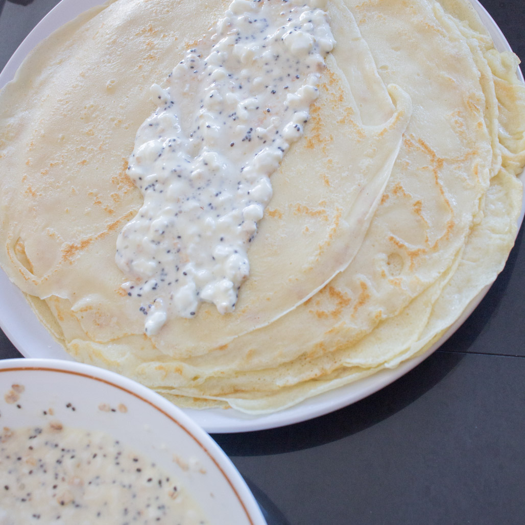 Cottage cheese filling spread across crepe | Baked cottage cheese stuffed crepes | A healthy make-ahead breakfast casserole recipe 