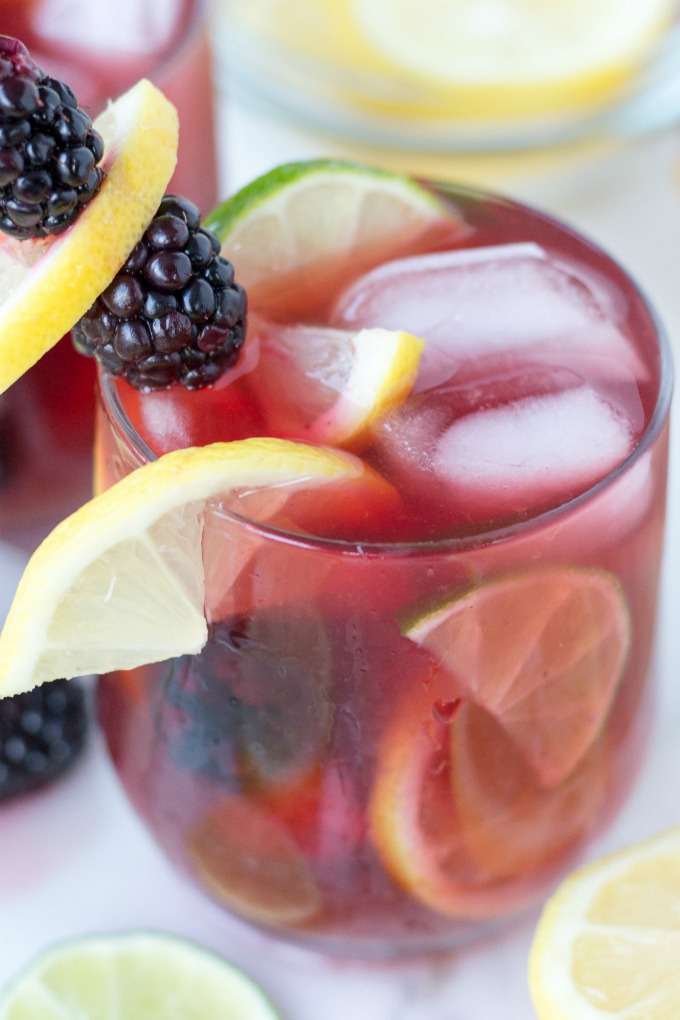 This Cranberry Lemon Blackberry Mocktail recipe is what affordable entertaining is all about. Make a big batch of this summer drink with cranberry juice, citrus, and fresh berries. Serve it as is by the glassful or add a splash of vodka to the glass for the perfect summer cocktail.