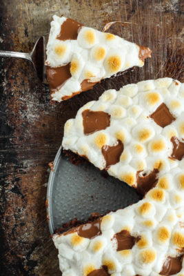 This blissful Campfire Inspired S'mores Dessert Pizza recipe is just what your family needs when they long for late summer days and sweet, gooey treats.