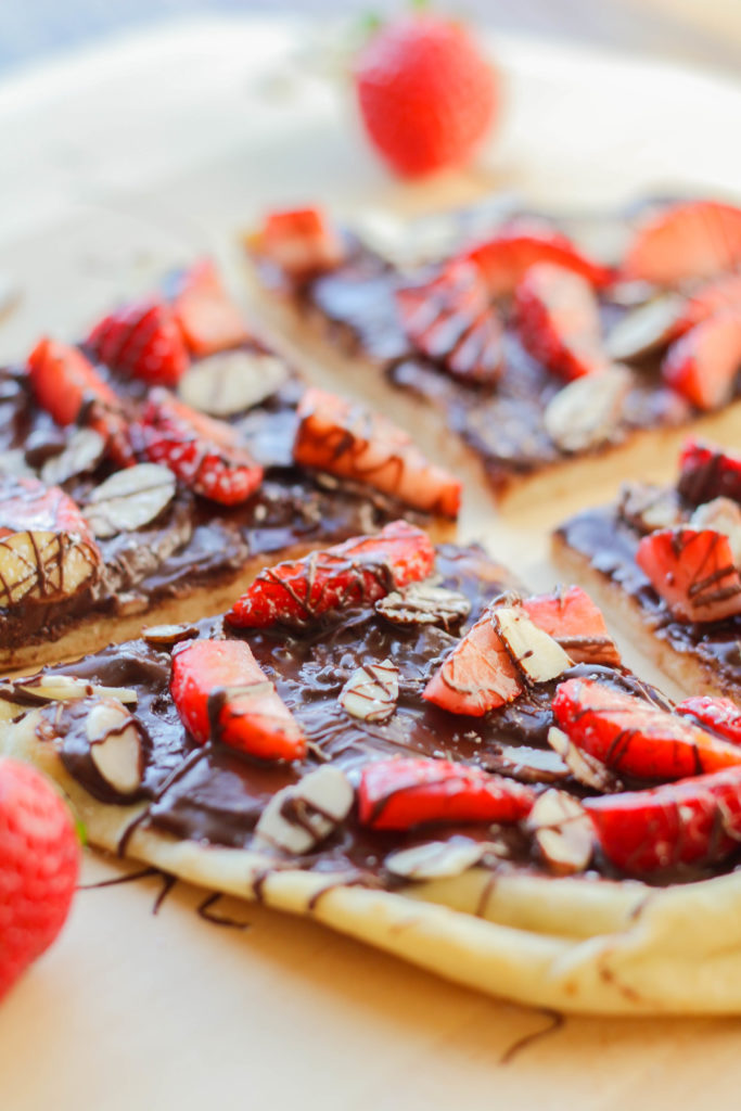 Treat yourself with this incredibly delicious Chocolate Strawberry Flatbread Pizza made with luscious chocolate spread, fresh berries, and slivered almonds.