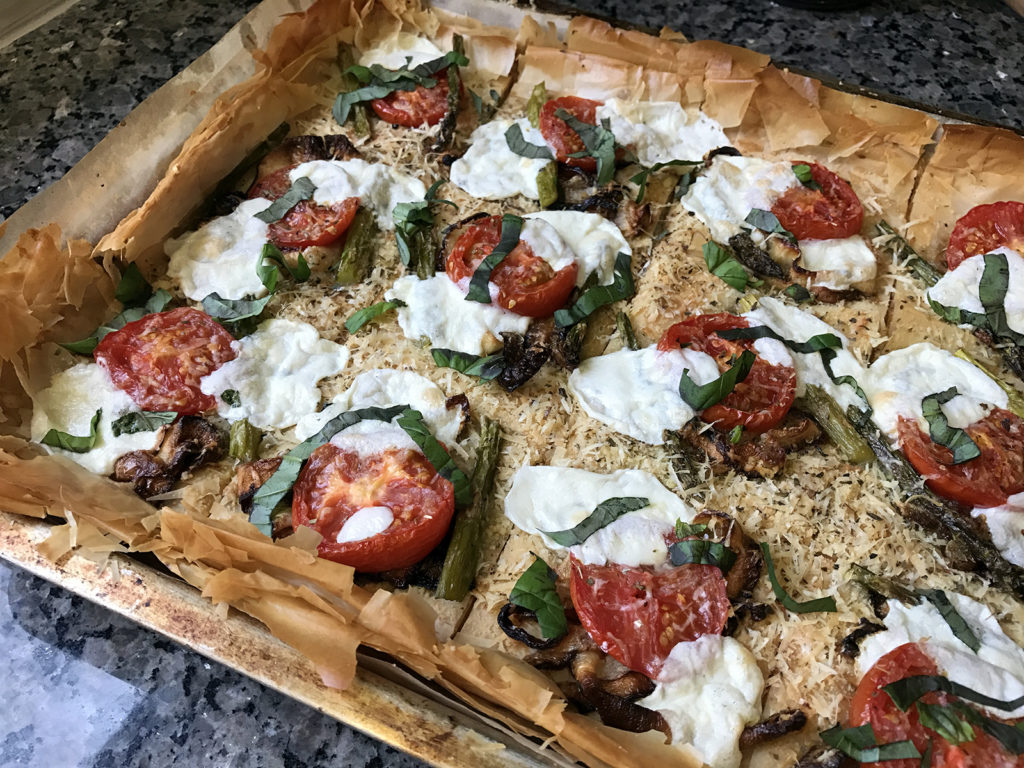 Step outside the traditional pizza box with flaky Roasted Vegetable Phyllo Dough Pizza recipe topped with savory vegetables, parmesan, and mozzarella.