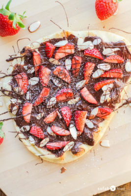 Combine your love of pizza and dessert with this incredibly delicious Chocolate Strawberry Flatbread Pizza recipe. Made with luscious chocolate spread, fresh berries, and slivered almonds, it is sure to be a family favorite.