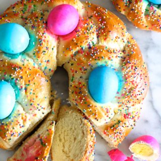 Your family will love to see this colorful Pane Di Pasqua, or Italian Easter Bread, on your holiday brunch table. It is a classic dish of slightly sweet, braided bread baskets with brightly-colored eggs woven in.