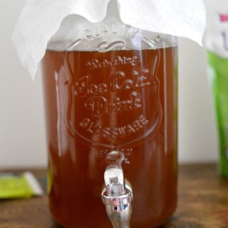 Learn how to make Kombucha Tea at home. You will fall in love with this healthy, fizzy drink with only four ingredients. This drink is packed with amazing health benefits and it's simple to make at home in five to seven days.