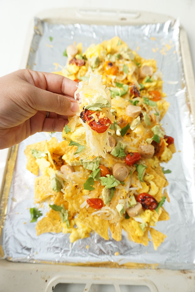 Breakfast meets dinner in these Loaded Breakfast Nachos perfect for special occasions or Sunday Brunch. Eggs, chicken hot dogs, cheese, avocado, tomatoes, and hash browns piled high on tortilla chips!