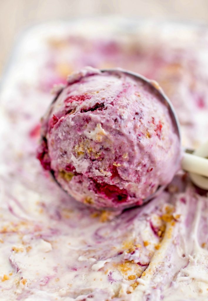 Made with a farmers market fresh berry sauce and filled with graham cracker pieces, this Creamy Berry Cheesecake Ice Cream is an easy no-bake dessert. A no-churn ice cream that’s better than the real deal!