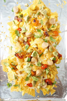 Breakfast meets dinner in these Loaded Breakfast Nachos perfect for special occasions or Sunday Brunch. Eggs, chicken hot dogs, cheese, avocado, tomatoes, and hash browns piled high on tortilla chips!