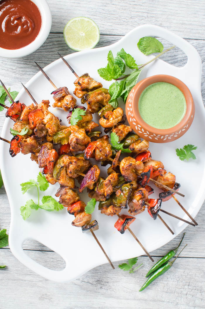 Very flavorful Smoky Grilled Chicken Tikki Kebabs are a perfect appetizer to please the crowd. Chicken chunks with vegetables marinated in a rich sauce and grilled to perfection on skewers.