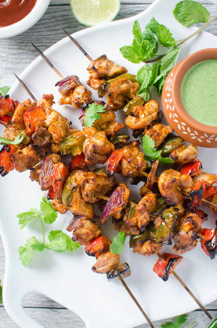 Very flavorful Smoky Grilled Chicken Tikki Kebabs are a perfect appetizer to please the crowd. Chicken chunks with vegetables marinated in a rich sauce and grilled to perfection on skewers.