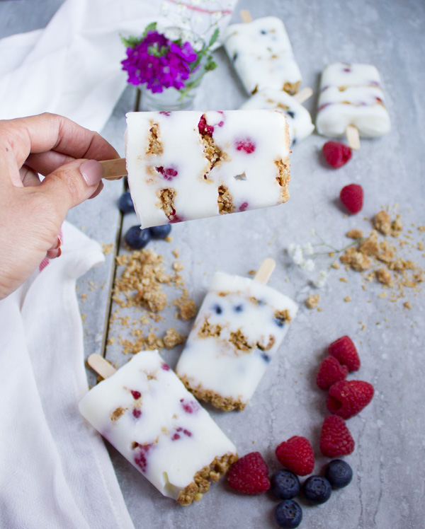 These refreshing Granola Crunch Berry Yogurt Popsicles are the perfect summer treat for the whole family! They’re sweet, crunchy, studded with berries, lusciously creamy, yet healthy and light. A protein packed sweet summer treat that you can make in minutes while your freezer does all the work.