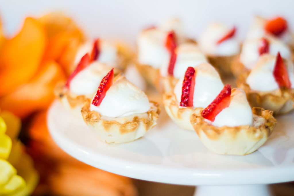 This super easy Lemon and Strawberry Curd Bites recipe is pretty perfect for little fingers for Summer Break. With homemade lemon strawberry curd in a light and crispy pre-made pastry shell garnished with fresh strawberries, your kids will enjoy every bite!