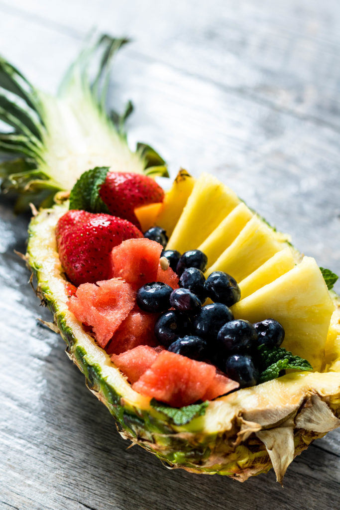 This insanely easy Fresh Fruit Salad recipe uses a pineapple as the vessel for a delightful presentation that's filled with fresh farmers market finds. Perfect for summer gatherings!