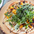 Fire up the grill and grab your best summer produce for this tasty GF Balsamic Glazed Grilled Peach Pizza recipe! Not only are we grilling the pizza, but the peaches too. Top it all off with spicy arugula and sweet balsamic glaze for the perfect gluten-free pizza!