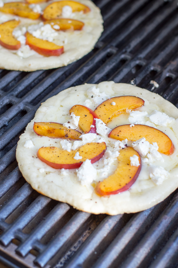 Fire up the grill and grab your best summer produce for this tasty Balsamic Glazed Grilled Peach Pizza recipe! Not only are we grilling the pizza, but the peaches too. Top it all off with spicy arugula and sweet balsamic glaze for the perfect summer-inspired pizza!