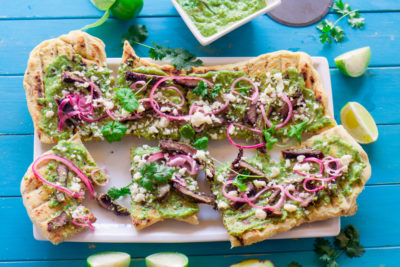 You can enjoy pizza night out on the patio when you make this Grilled Chimichurri Steak Pizza recipe. Grilling the pizza dough adds a smoky essence to the pizza and brings on the flavors of summer.