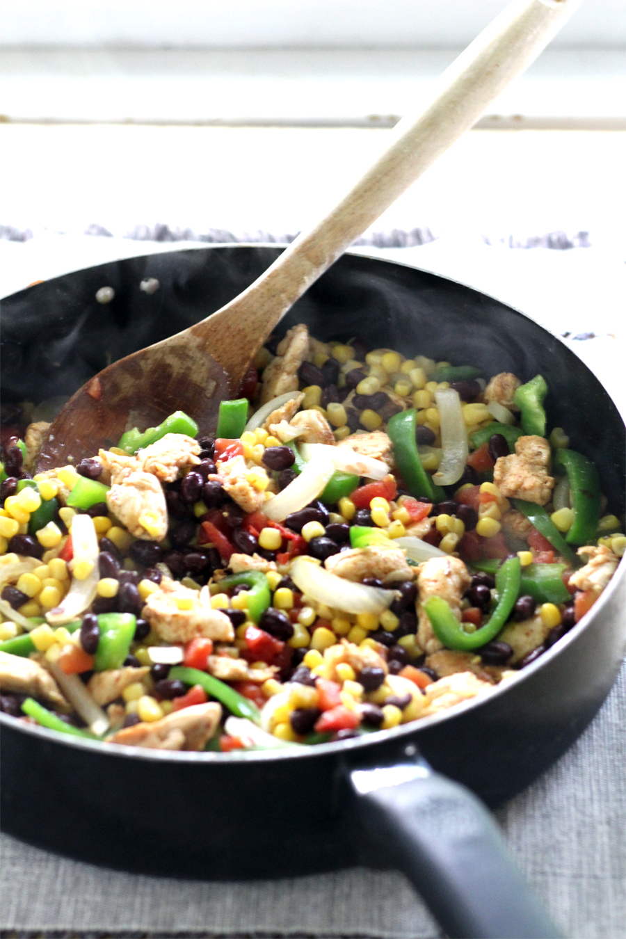 What's not to love about this Chicken Fajita Fiesta Skillet recipe? Tender chicken combined with peppers, onions, black beans, corn, and Mexican rice. One skillet, minimal mess, and full of bold flavors!