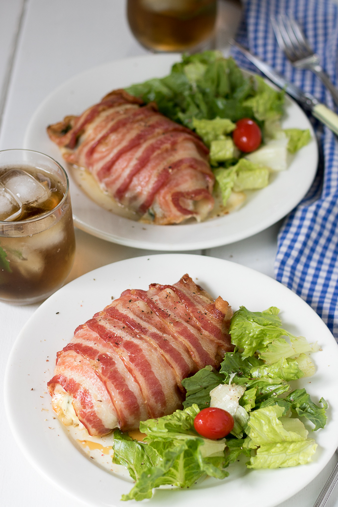 You are going to love this delicious Bacon Wrapped Stuffed Chicken Breasts recipe full of fresh spinach and white cheddar cheese. Cooking for two just got a lot more delightful!