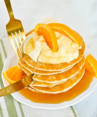 These Crepe Suzette Inspired Pancakes or Suzette Shortstacks is a recipe inspired by one of home cooking's greatest heroes, Julie Child. Combine the luscious flavors of citrus and liqueur for an elegant Sunday brunch!