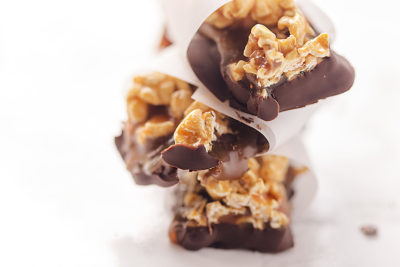 Who doesn't love caramel-covered popcorn dipped in chocolate? These gluten-free Chocolate Caramel Popcorn Bars are decadent small bites that deliver a sweet and salty combo with every mouthful.