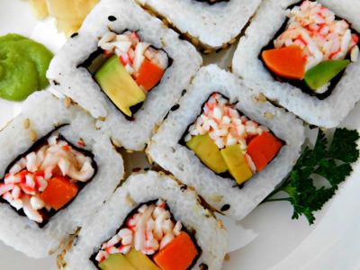Gather with friends to make these super simple California Sushi Rolls instead of going out for dinner. Rice, crab, avocado, carrots, and cucumber all wrapped in a nori roll.