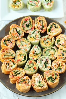 Veggie Pinwheels Party Appetizer. Perfect for tailgating or potlucks. Fresh veggies, ranch cream cheese, and cheese in tortillas, cut into small bites!