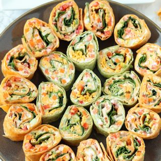 Veggie Pinwheels Party Appetizer. Perfect for tailgating or potlucks. Fresh veggies, ranch cream cheese, and cheese in tortillas, cut into small bites!
