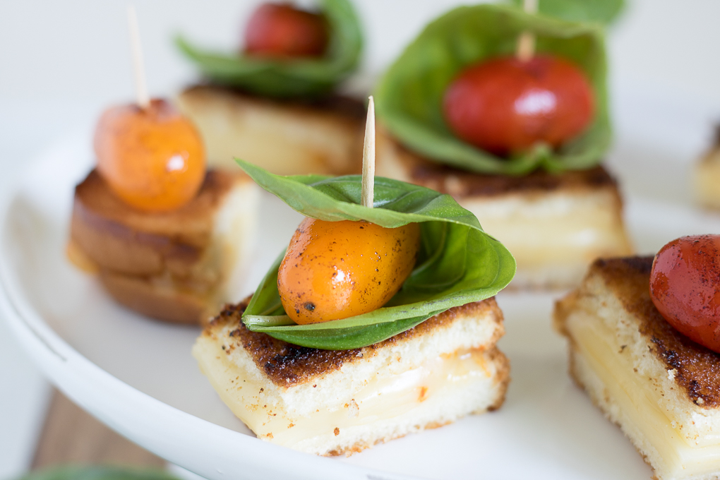 Grilled Cheese Tomato Bites topped with blistered sweet grape tomatoes and fresh basil leaves are an afternoon snack recipe you can't resist.