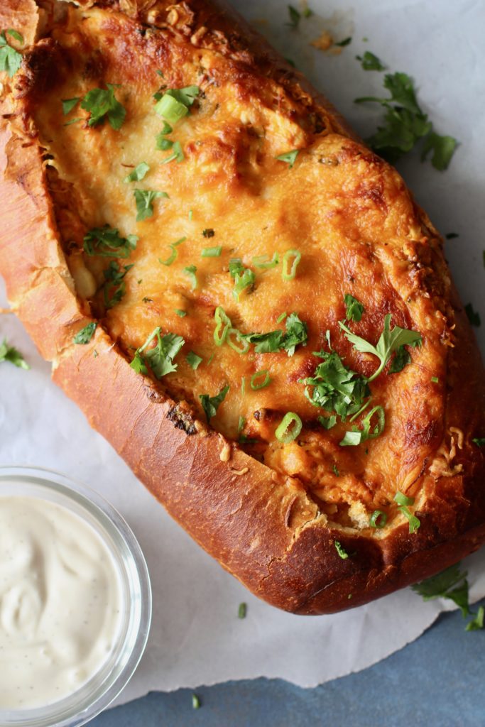 This Buffalo Chicken Stuffed Bread will be the highlight at your next football tailgate party. A creamy Buffalo Chicken Dip served up neatly in a bread vessel for a show-stopping appetizer everyone will love!