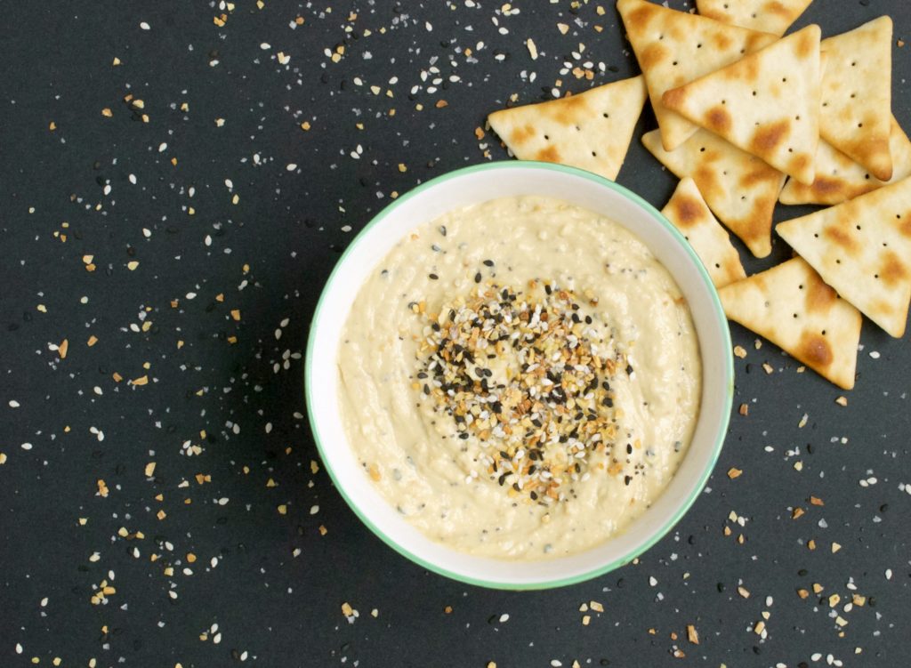 Just like your favorite bagel, this Everything Bagel Hummus recipe uses black and white sesame seeds, poppy seeds, onion flakes, garlic flakes, and sea salt.