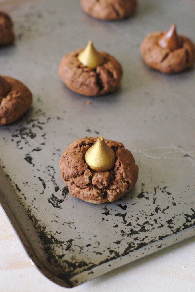 Midnight Kiss Peanut Butter Cookies - A simple yet delicious treat perfect for New Year's Eve! Indulgent peanut butter chocolate cookies with a golden Hershey's Kiss in the middle!