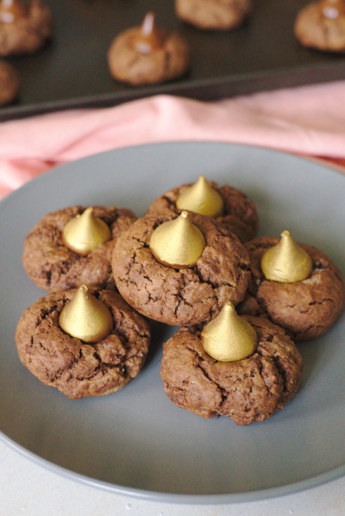 Midnight Kiss Peanut Butter Cookies - A simple yet delicious treat perfect for New Year's Eve! Indulgent peanut butter chocolate cookies with a golden Hershey's Kiss in the middle!