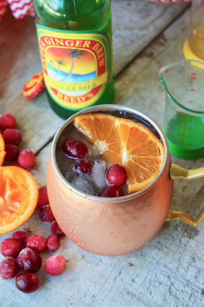 Looking for a refreshing holiday drink? Grab a copper mug and make this amazing Cranberry Orange Moscow Mule! Zesty, fresh, and delicious; this cocktail is exactly what your party needs.