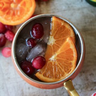 Looking for a refreshing holiday drink? Grab a copper mug and make this amazing Cranberry Orange Moscow Mule! Zesty, fresh, and delicious; this cocktail is exactly what your party needs.