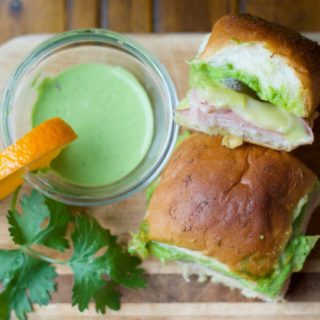 These savory little Cilantro-Citrus Aioli Cuban Sliders are perfect hand warmers for a cool autumn tailgate. These baked small bites pack a powerful flavor punch that's sure to be a crowd pleaser!