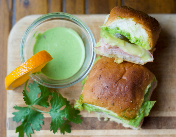 These savory little Cilantro-Citrus Aioli Cuban Sliders are perfect hand warmers for a cool autumn tailgate. These baked small bites pack a powerful flavor punch that's sure to be a crowd pleaser!