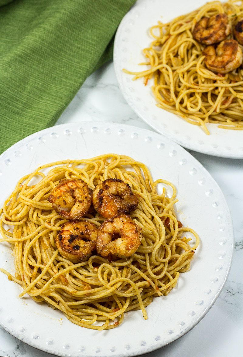 This 30-Minute One-Pot Shrimp Pasta Dinner is an easy dinner with simple ingredients. The shrimp is perfectly juicy and filled with flavor, and the pasta is tossed in a garlicky tomato sauce that's sure to be loved by all!