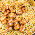 This 30-Minute One-Pot Shrimp Pasta Dinner is an easy dinner with simple ingredients. The shrimp is perfectly juicy and filled with flavor, and the pasta is tossed in a garlicky tomato sauce that's sure to be loved by all!