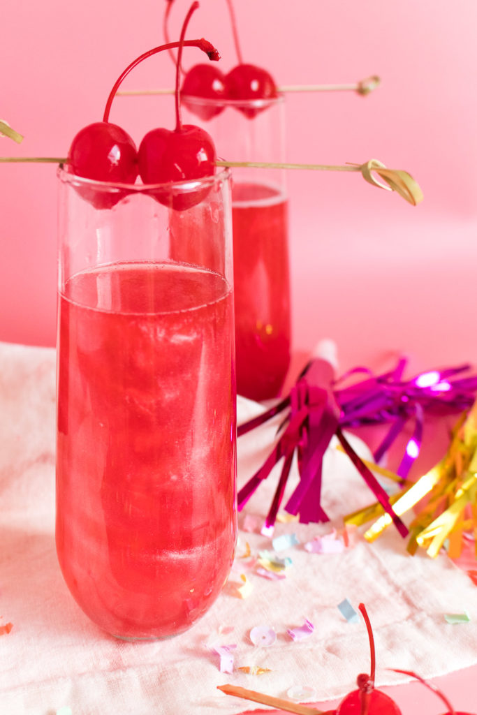 Ring in the new year with this Swirled Cranberry Champagne Cocktail made with grenadine, cranberry juice, and champagne that swirls and shines thanks to a secret ingredient!