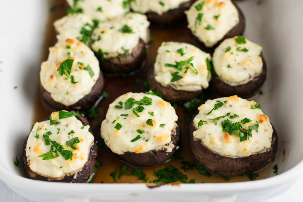 Tailgating and holiday parties just got more tasty with this Cheesy Stuffed Mushrooms recipe! All you need is baby bellas, cream cheese, parmesan cheese, greek yogurt, a few spices, and about 30 minutes.