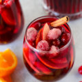 This Apple Cranberry Sangria recipe is loaded with seasonal produce. This red wine based holiday cocktail is perfect for entertaining guests! Red wine, apple brandy, cranberry juice, cinnamon sticks, apples, oranges, and fresh cranberries all work together to make this the tastiest sangria ever.
