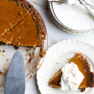Whip up this Gluten-Free Walnut Crust Pumpkin Pie made from seasonal, roasted pumpkin and warming spices if you want to keep your holiday dessert menu fresh and healthy.
