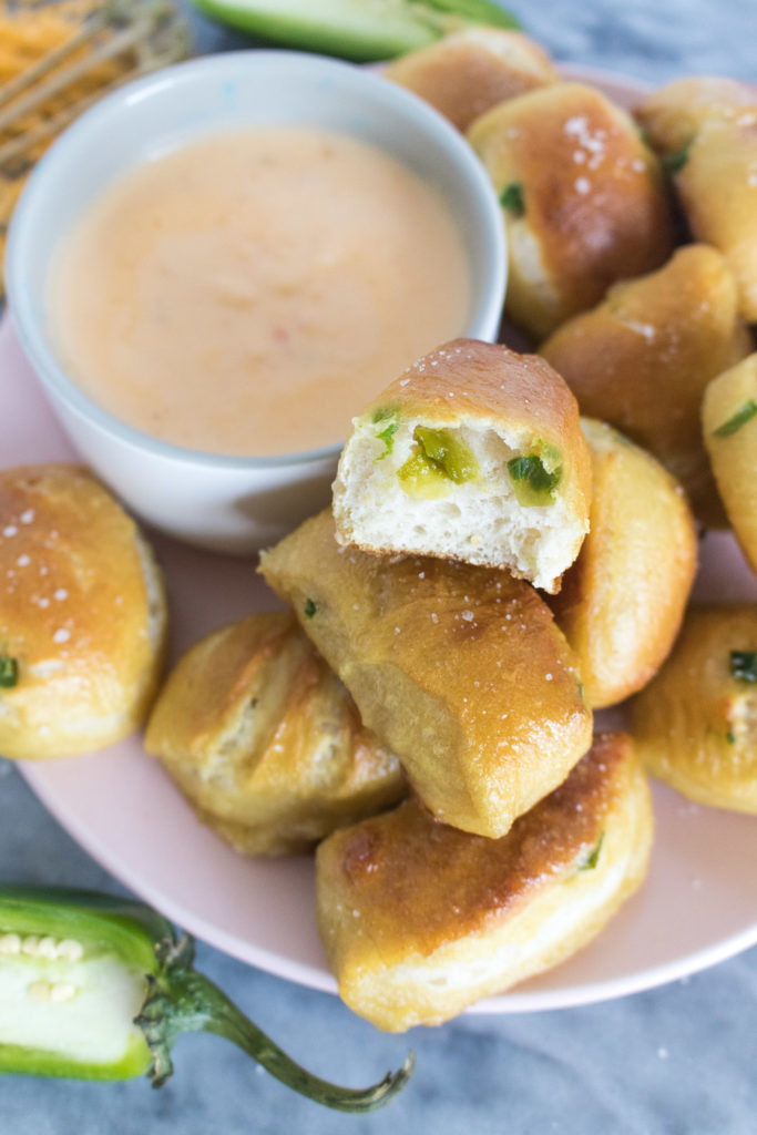 No one can resist these homemade Cheesy Jalapeño Pretzel Bites. Served with a spicy side of Cheese Dipping Sauce, these mini bites are absolutely addictive!